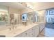 Bright bathroom with a dual sink vanity, large mirrors, and a walk-in closet nearby at 168 Maple Grove Ter, Peachtree City, GA 30269