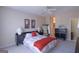 A bedroom with light colored walls with an ensuite bath and large bed at 168 Maple Grove Ter, Peachtree City, GA 30269