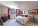 Cozy bedroom with a bright window, double bed with decorative pillows, side table, and soft neutral carpet at 168 Maple Grove Ter, Peachtree City, GA 30269