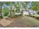 A suburban house with a stone and siding facade, surrounded by mature trees and landscaping at 168 Maple Grove Ter, Peachtree City, GA 30269