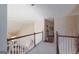 Upstairs hallway with wood trim and white railings, a view of downstairs living room, and a clear walkway at 168 Maple Grove Ter, Peachtree City, GA 30269