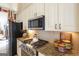 Chef's kitchen with granite countertops, stainless steel appliances, and custom cabinetry at 168 Maple Grove Ter, Peachtree City, GA 30269
