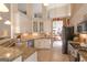 Open kitchen boasts granite countertops, stainless appliances, and light cabinetry at 168 Maple Grove Ter, Peachtree City, GA 30269