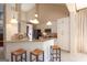 Spacious kitchen boasting white cabinets, granite countertops, breakfast bar, and pendant lighting at 168 Maple Grove Ter, Peachtree City, GA 30269