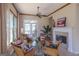 Cozy living room with fireplace, tile floors, wicker chairs, and lots of natural light at 168 Maple Grove Ter, Peachtree City, GA 30269
