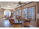 Bright living room with wicker furniture, multiple windows, fireplace, and neutral tones at 168 Maple Grove Ter, Peachtree City, GA 30269