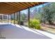 View of the home's covered patio, featuring a concrete floor and wooded backyard at 168 Maple Grove Ter, Peachtree City, GA 30269
