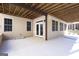 Covered patio with sliding door access, tan walls, multiple windows, and concrete floor at 168 Maple Grove Ter, Peachtree City, GA 30269