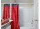 Close up of a tiled bathtub and shower with decorative curtain rod at 168 Maple Grove Ter, Peachtree City, GA 30269