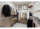 Spacious walk-in closet featuring ample shelving, rods, and clothing storage with neutral carpeting at 168 Maple Grove Ter, Peachtree City, GA 30269