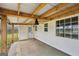 Covered back porch with wood beams, a ceiling fan, and outdoor lighting at 521 Cody Ln, Mcdonough, GA 30252