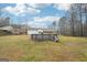 A backyard featuring an above-ground pool with the white house and covered porch as a backdrop at 521 Cody Ln, Mcdonough, GA 30252