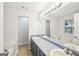 Bathroom featuring a large mirror, double sinks and separate tub at 521 Cody Ln, Mcdonough, GA 30252