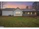 The exterior of the home features a covered back porch, white siding, and a well-manicured lawn at 521 Cody Ln, Mcdonough, GA 30252