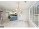 Kitchen adjacent to a dining area with marble floors and a stylish ceiling light at 521 Cody Ln, Mcdonough, GA 30252