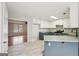 Well-lit kitchen with marble floors adjacent to a cozy living area at 521 Cody Ln, Mcdonough, GA 30252