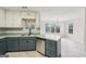 Stylish kitchen island and sink with a view to a cozy dining area at 521 Cody Ln, Mcdonough, GA 30252