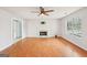 Bright and airy living room features a fireplace, wood floors, ceiling fan, and ample natural light at 521 Cody Ln, Mcdonough, GA 30252