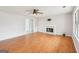 Bright and airy living room features a fireplace, wood floors, ceiling fan, and ample natural light at 521 Cody Ln, Mcdonough, GA 30252