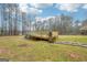 Backyard above-ground pool featuring a wooden deck and paver steps to the grassy lawn at 521 Cody Ln, Mcdonough, GA 30252