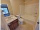 Bright bathroom featuring a sink, toilet, and bathtub with a shower at 3535 Waldrop Trl, Decatur, GA 30034