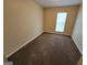 Cozy bedroom featuring neutral walls, carpet floors, and a window providing natural light at 3535 Waldrop Trl, Decatur, GA 30034
