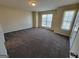 Bright and airy bedroom with plush carpeting, neutral walls, and large window at 3535 Waldrop Trl, Decatur, GA 30034