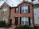 Charming brick townhouse with black shutters, a well-maintained front yard, and stone accents at 3535 Waldrop Trl, Decatur, GA 30034