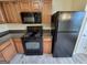 Well-equipped kitchen with black appliances, wood cabinets and neutral countertops at 3535 Waldrop Trl, Decatur, GA 30034