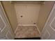 Functional laundry area with tile floors, shelving, and connections for washer and dryer at 3535 Waldrop Trl, Decatur, GA 30034
