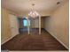 Spacious living room with neutral walls, a modern chandelier, and plush carpeting at 3535 Waldrop Trl, Decatur, GA 30034