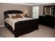 Spacious bedroom featuring a large bed, dresser, and window with shutter blinds at 4286 Rosehall Ct, South Fulton, GA 30349