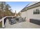 The back deck area has seating and a fire pit with wood railing at 1144 Pickets Ridge Dr, Locust Grove, GA 30248