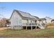 View of the home's backyard, deck and solar panels on the roof at 1144 Pickets Ridge Dr, Locust Grove, GA 30248