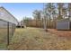 Spacious backyard with a deck, storage shed, and secure black chain-link fence at 1144 Pickets Ridge Dr, Locust Grove, GA 30248