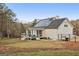 View of the back of the house and yard featuring a deck and covered patio at 1144 Pickets Ridge Dr, Locust Grove, GA 30248