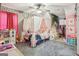 Charming bedroom with a canopy bed, playful decor, and ample natural light at 1144 Pickets Ridge Dr, Locust Grove, GA 30248