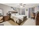 Spacious bedroom featuring a ceiling fan, wall decorations, and ample natural light at 1144 Pickets Ridge Dr, Locust Grove, GA 30248