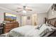 Bedroom featuring a ceiling fan, TV on bureau, and direct access to bathroom at 1144 Pickets Ridge Dr, Locust Grove, GA 30248