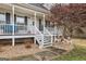 Close-up of a welcoming covered front porch with festive holiday decorations at 1144 Pickets Ridge Dr, Locust Grove, GA 30248