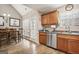Bright kitchen/dining combo with wood cabinets, stainless appliances, and luxury vinyl plank flooring at 1144 Pickets Ridge Dr, Locust Grove, GA 30248