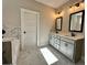 Elegant bathroom with marble floors, double vanity with gray cabinets, and modern fixtures at 2141 Bradbury Rd # 1, Moreland, GA 30259