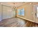 Bright dining area with hardwood floors, ship lap accent wall, modern chandelier, and large window at 2141 Bradbury Rd # 1, Moreland, GA 30259