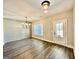 Bright dining area with hardwood floors, ship lap accent wall, modern chandelier, and large window at 2141 Bradbury Rd # 1, Moreland, GA 30259