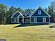 Charming new construction home featuring a symmetrical design with a large lawn and mature trees at 2141 Bradbury Rd # 1, Moreland, GA 30259