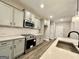 Modern kitchen featuring stainless steel appliances, gray cabinets, and sleek countertops at 2141 Bradbury Rd # 1, Moreland, GA 30259