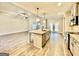 Open kitchen with stainless steel appliances, gray cabinets, island sink and view to living area at 2141 Bradbury Rd # 1, Moreland, GA 30259