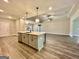 Open concept kitchen featuring stainless steel appliances, gray cabinets, island sink and view to living area at 2141 Bradbury Rd # 1, Moreland, GA 30259