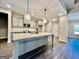 Well-lit kitchen featuring a center island, stainless steel appliances, and gray cabinets at 2141 Bradbury Rd # 1, Moreland, GA 30259