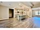 Open concept kitchen & living area with stainless appliances, island sink, and hardwood floors at 2141 Bradbury Rd # 1, Moreland, GA 30259